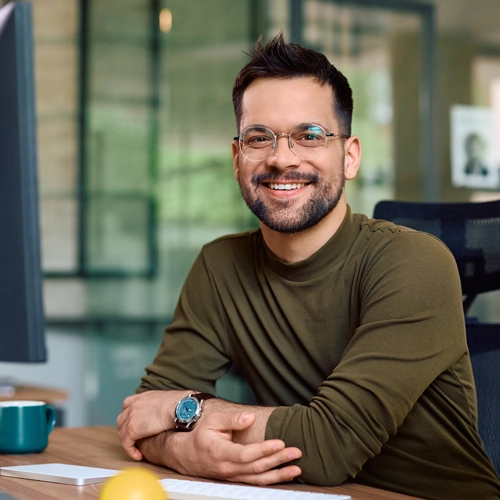 smiling man on his desk