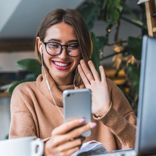 woman waving to the phone